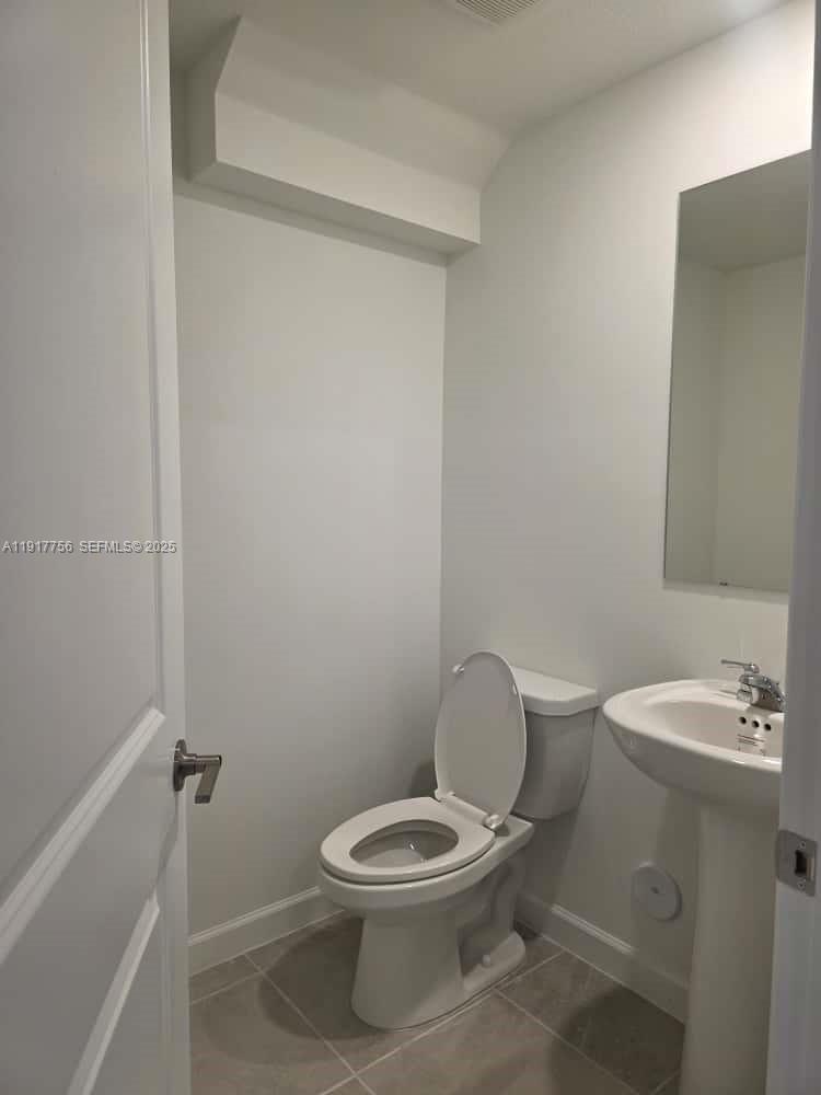 17875 Southwest 359 Terrace Homestead, FL 33034 - Photo 19 of 20 a white toilet sitting next to a bathroom sink