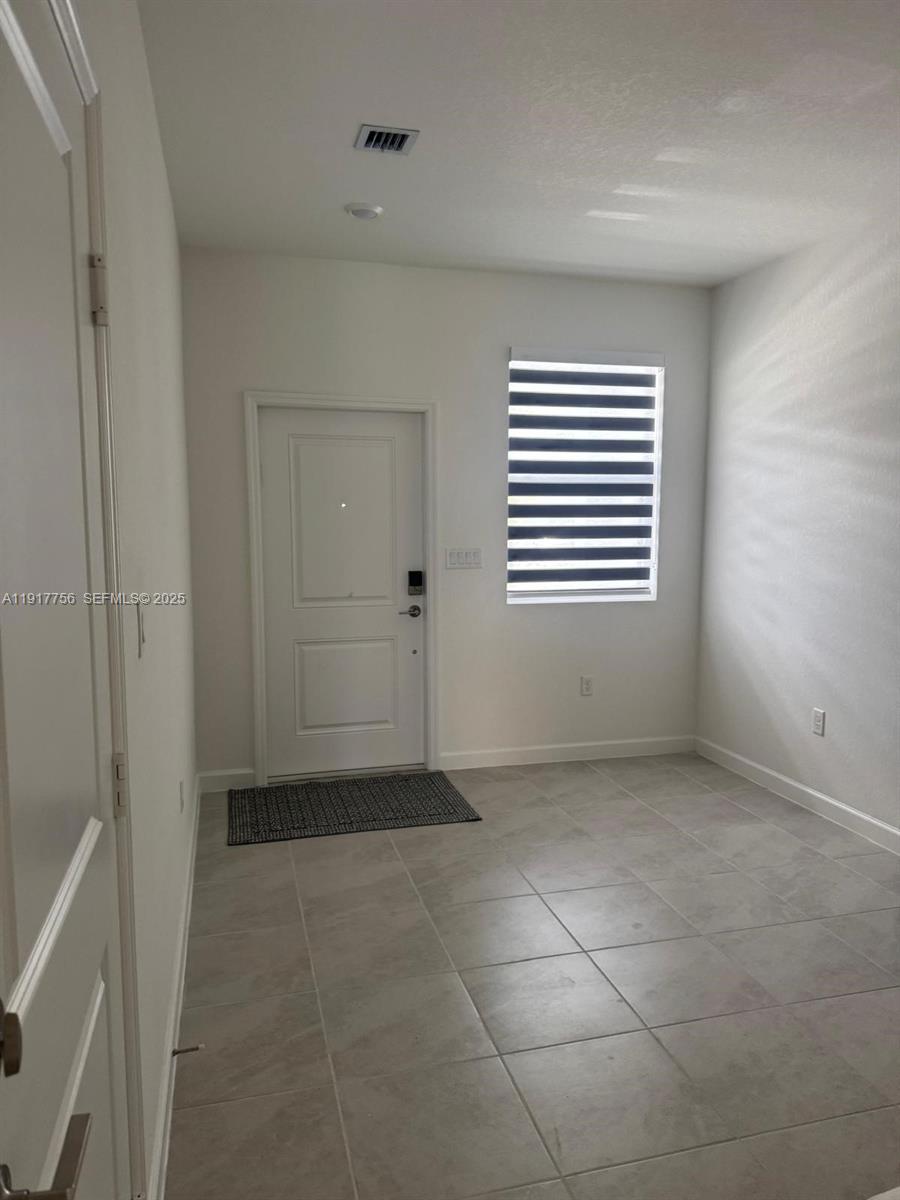 17875 Southwest 359 Terrace Homestead, FL 33034 - Photo 2 of 20 a view of an empty room with a window