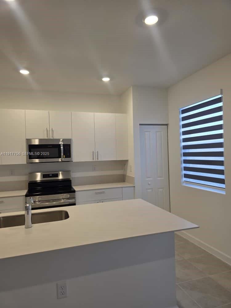17875 Southwest 359 Terrace Homestead, FL 33034 - Photo 5 of 20 a kitchen with kitchen island a stove and a refrigerator