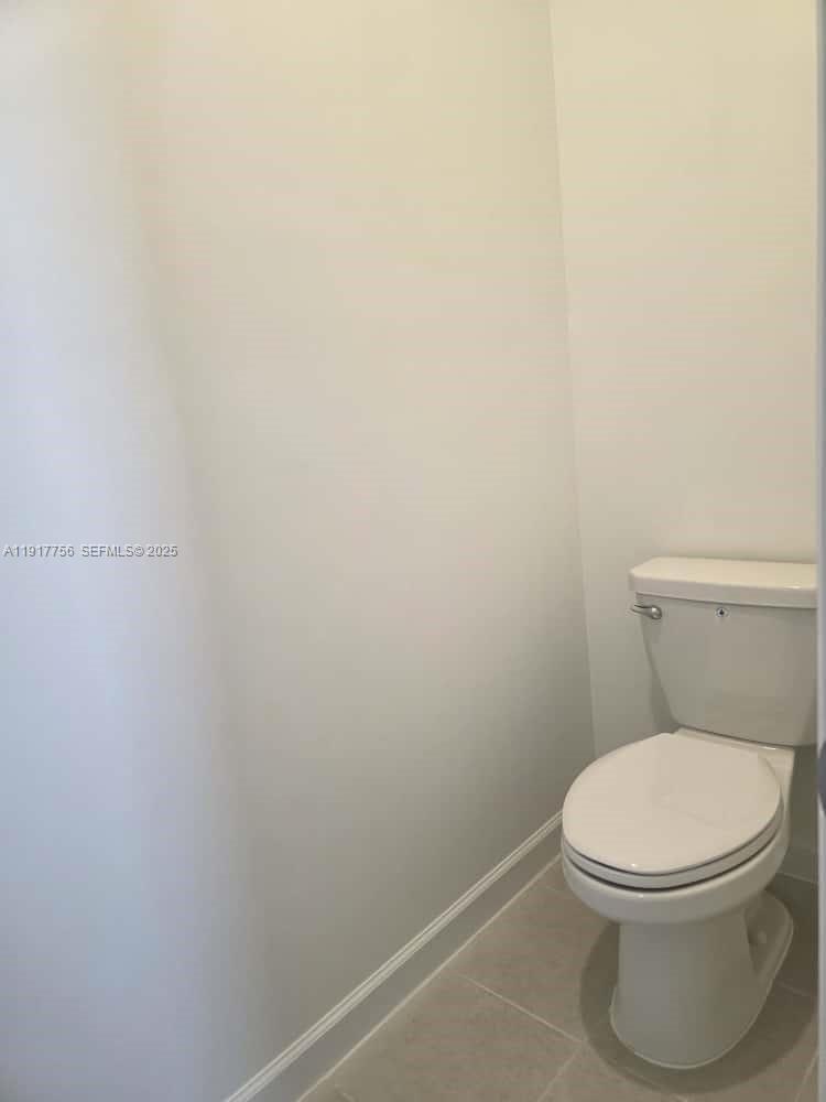 17875 Southwest 359 Terrace Homestead, FL 33034 - Photo 9 of 20 a white toilet sitting next to a white sink