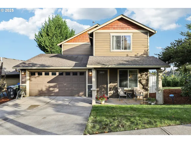 a front view of a house with a yard table and chairs