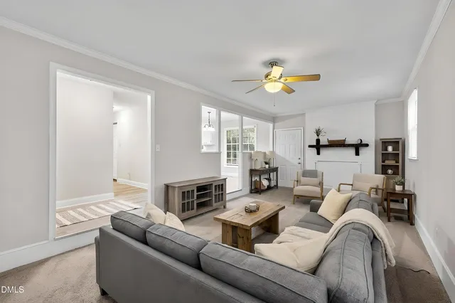 a living room with furniture fireplace and a window