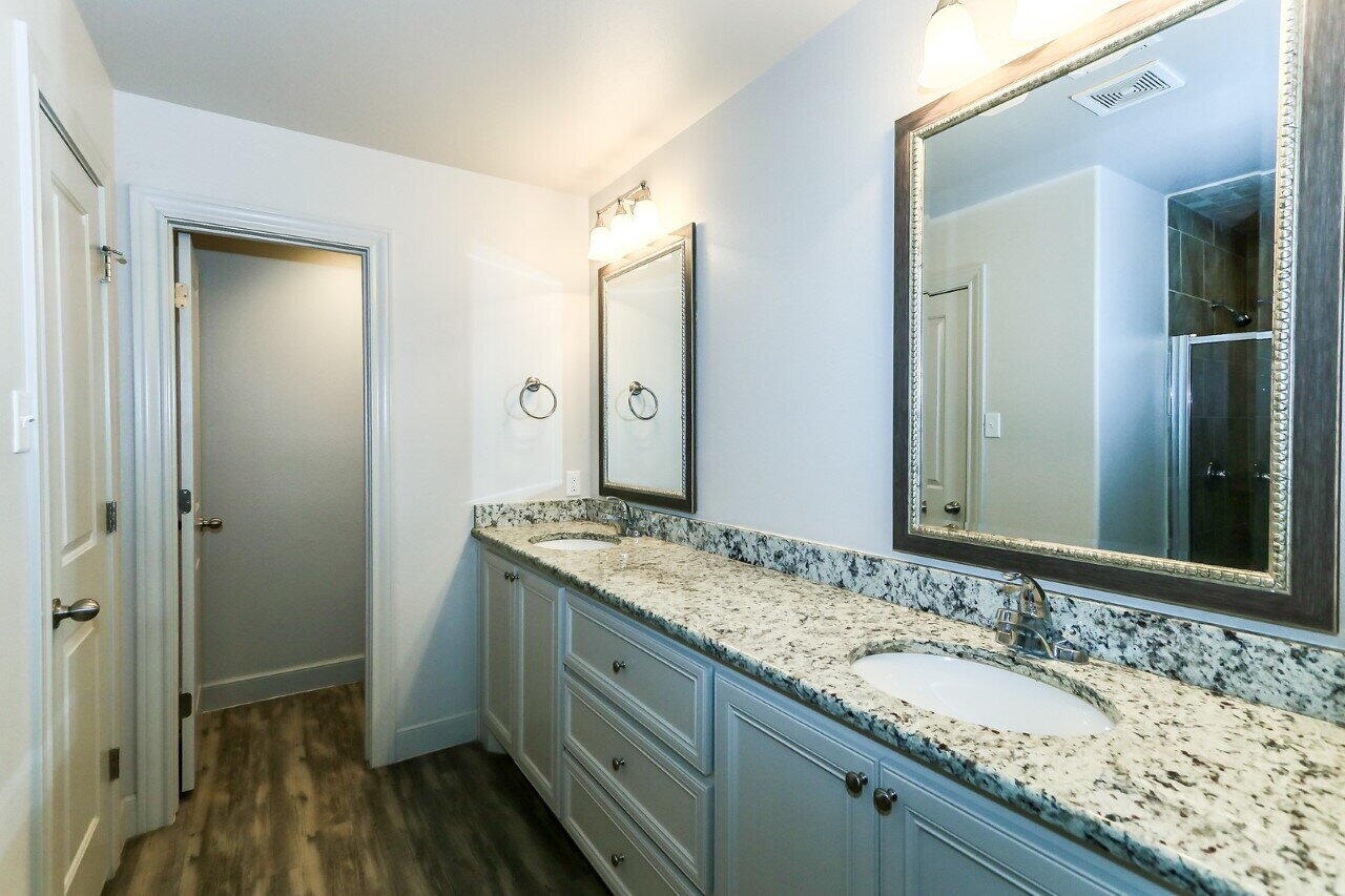 3814 133rd Street, Unit B Lubbock, TX 79423 - Photo 8 of 13 a bathroom with a granite countertop sink and a mirror