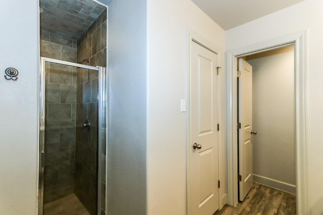 3814 133rd Street, Unit B Lubbock, TX 79423 - Photo 9 of 13 a bathroom with a glass shower door
