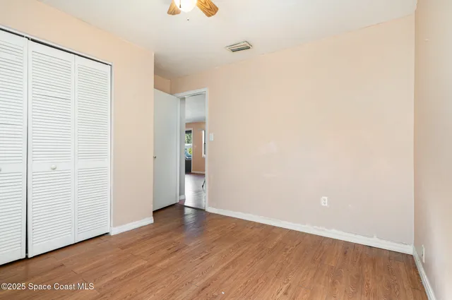 an empty room with wooden floor