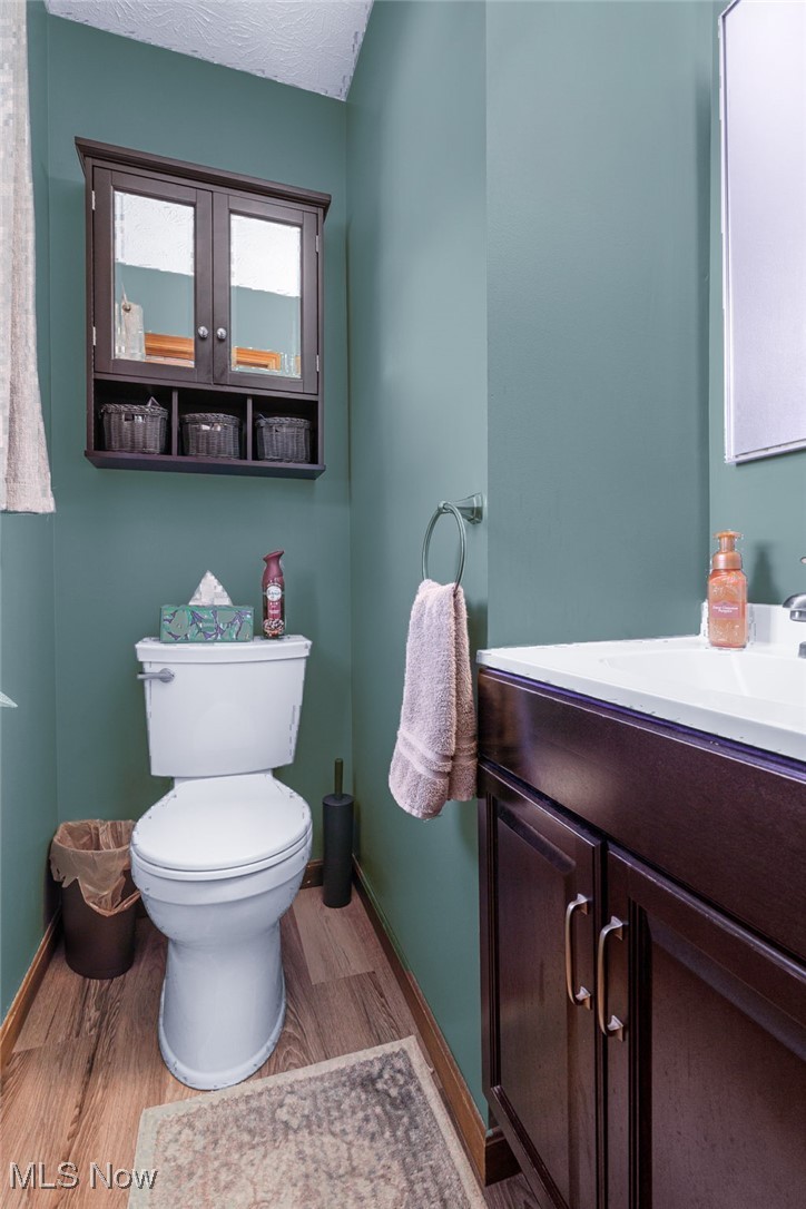 1521 Bravado Road Southwest Canton, OH 44706 - Photo 13 of 37 Bathroom featuring vanity, light wood finished floors, and a textured ceiling