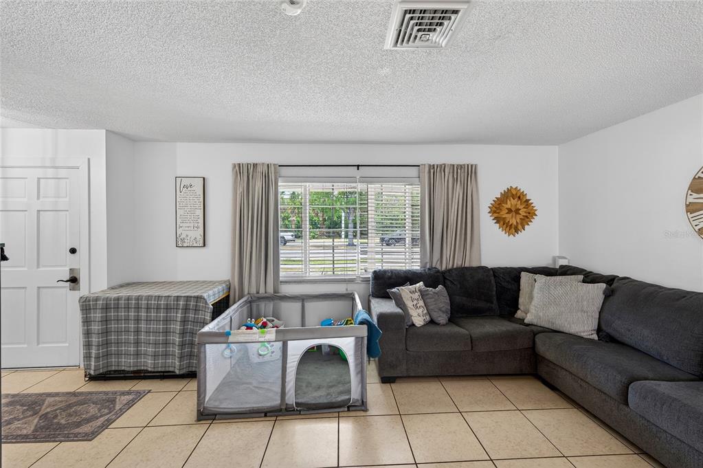 532 Center Road Venice, FL 34285 - Photo 16 of 68 a living room with furniture and a window