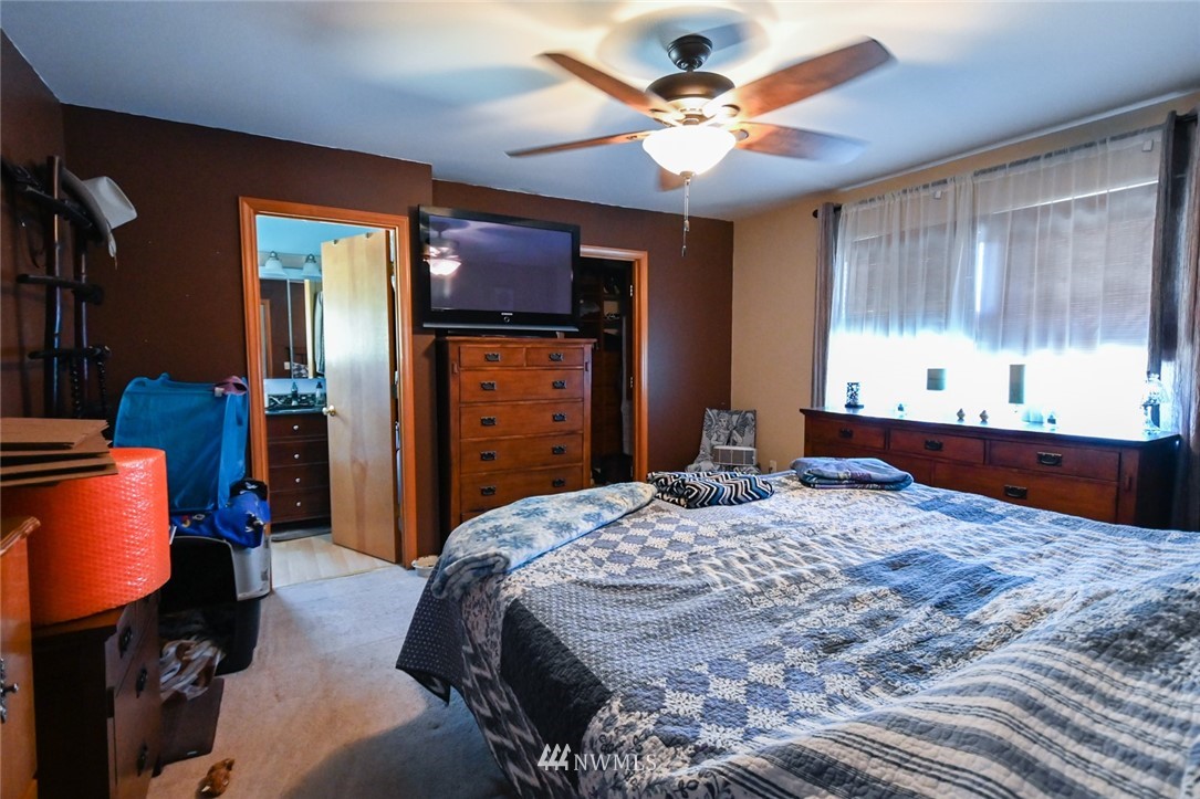 1018 Gohr Road Sultan, WA 98294 - Photo 14 of 16 a bedroom with a bed and a chandelier