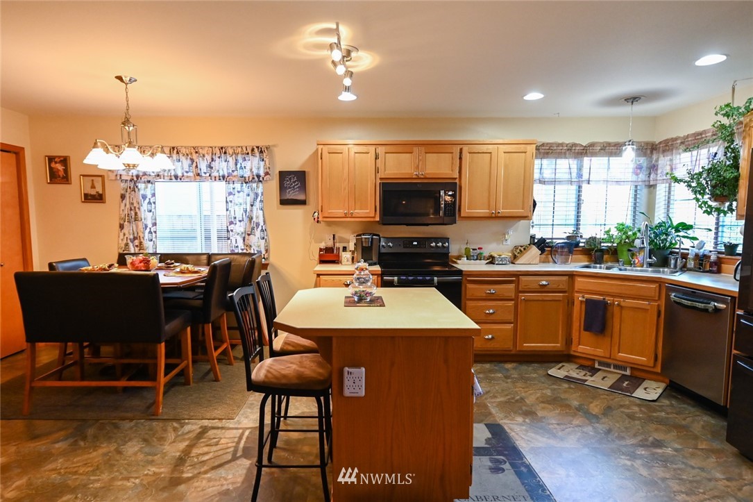 1018 Gohr Road Sultan, WA 98294 - Photo 4 of 16 a kitchen with a table chairs sink and cabinets