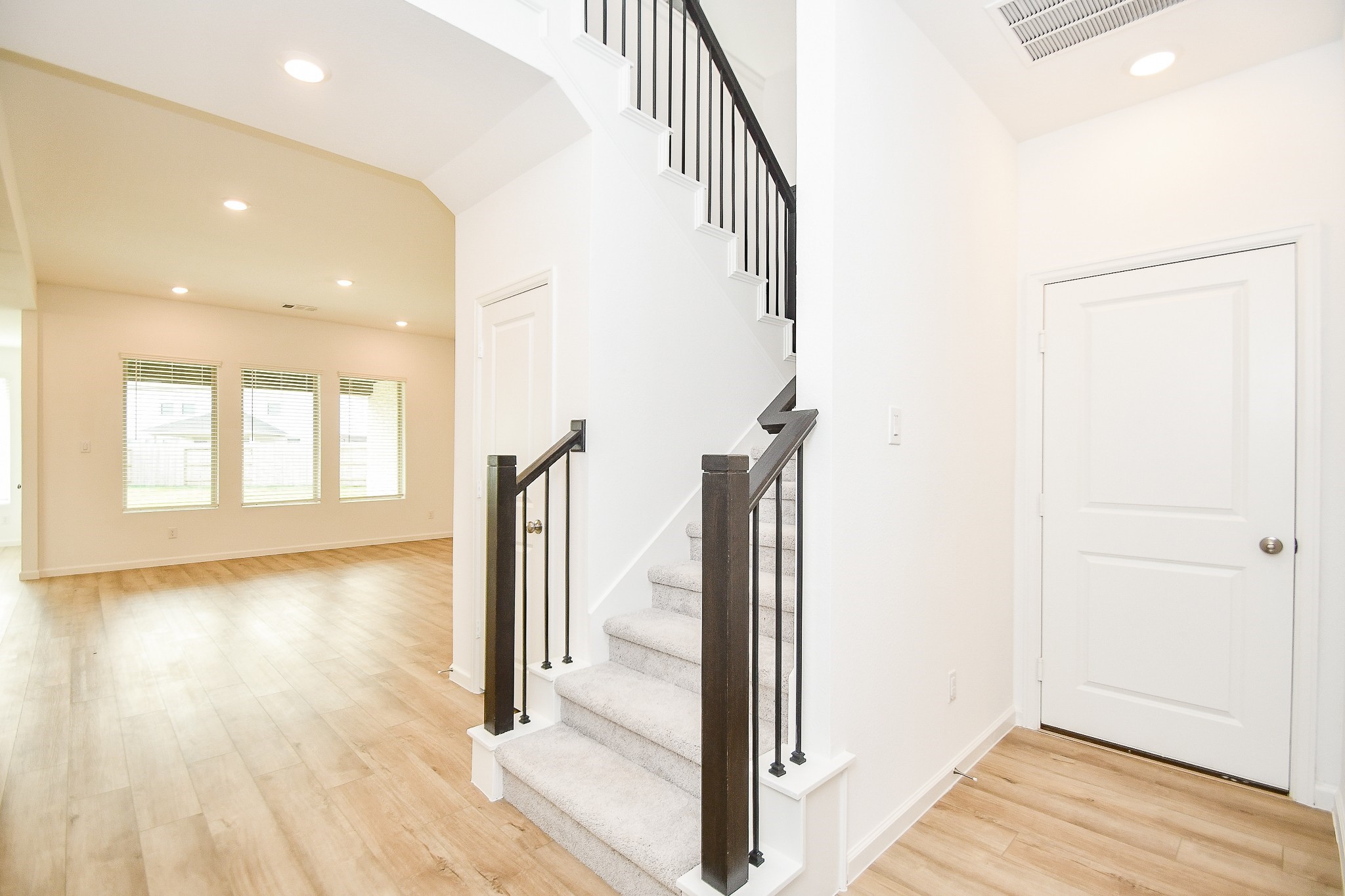 5624 Frst Cv Drive Rosenberg, TX 77469 - Photo 3 of 38 a view of a hallway with wooden floor and staircase