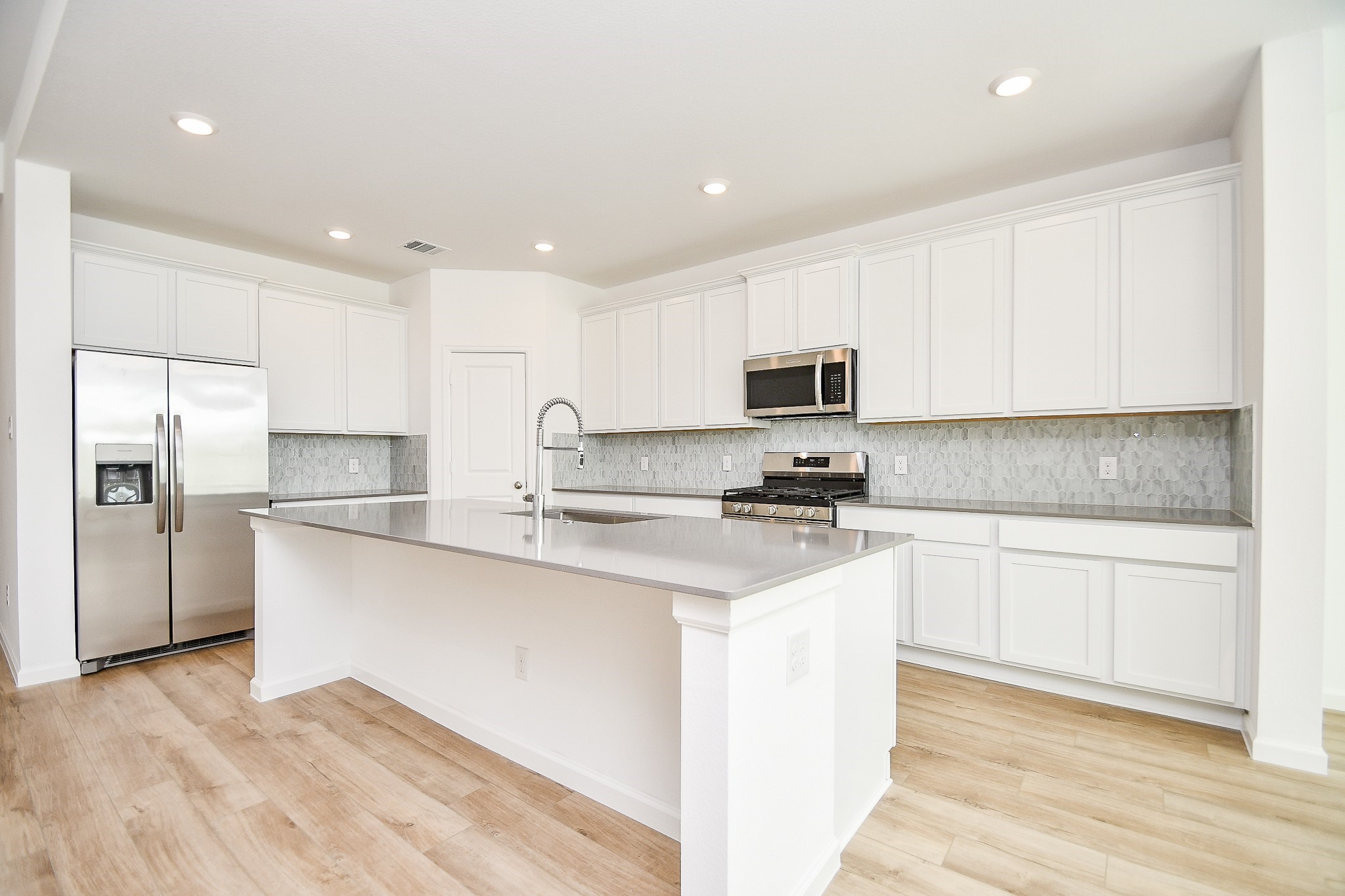 5624 Frst Cv Drive Rosenberg, TX 77469 - Photo 5 of 38 a kitchen with stainless steel appliances granite countertop a stove a sink and a refrigerator