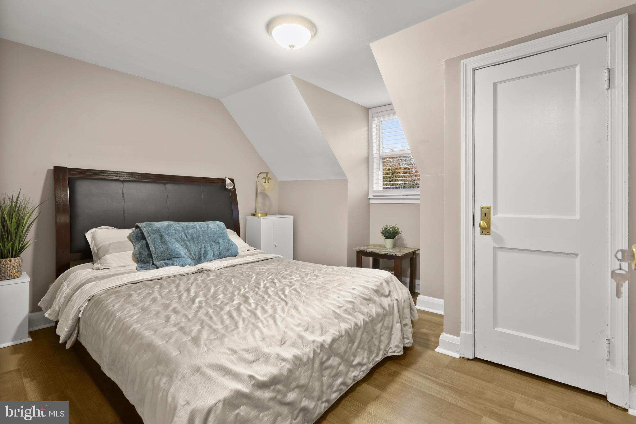 3608 Kenmar Road Baltimore, MD 21244 - Photo 29 of 46 a bedroom with a bed and wooden floor