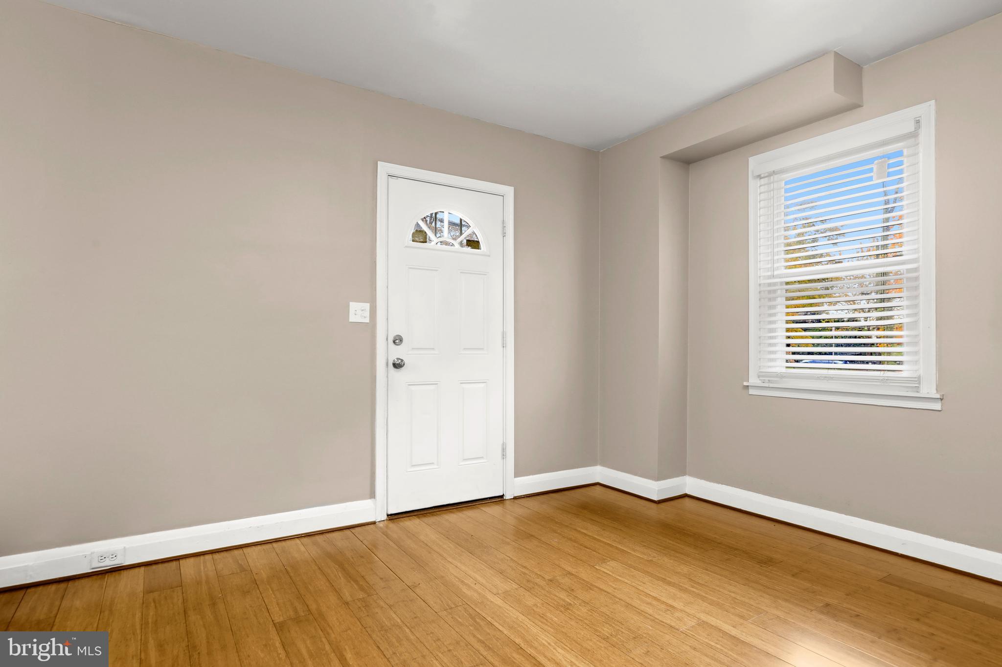 3608 Kenmar Road Baltimore, MD 21244 - Photo 4 of 46 an empty room with wooden floor and windows
