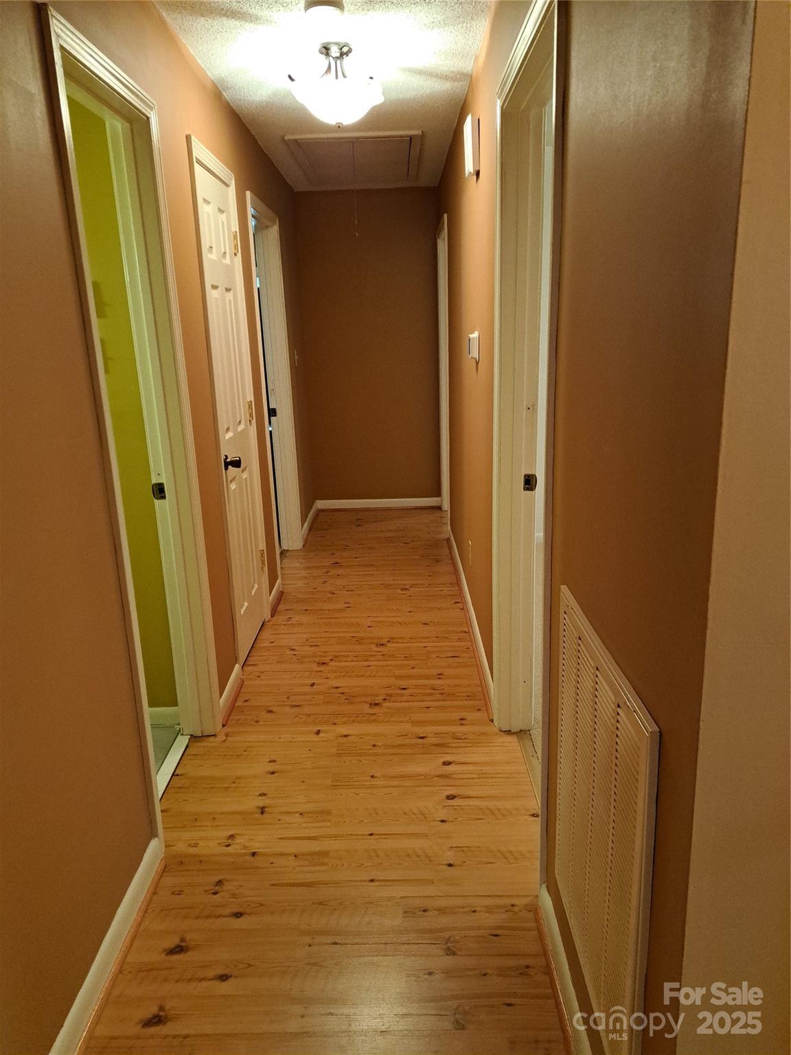 123 Softwind Lane Concord, NC 28025 - Photo 15 of 42 a view of a hallway with wooden floor