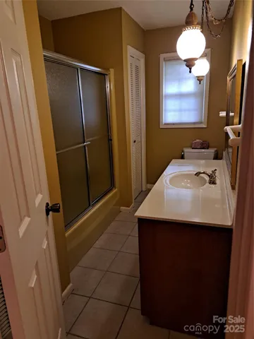 a bathroom with a sink vanity and a mirror