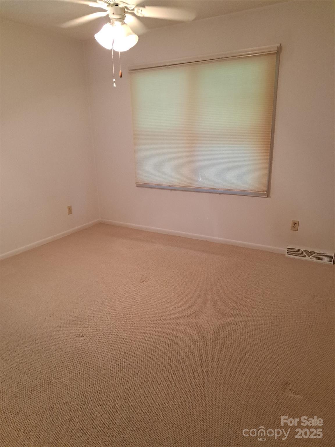 123 Softwind Lane Concord, NC 28025 - Photo 18 of 42 an empty room with a chandelier fan