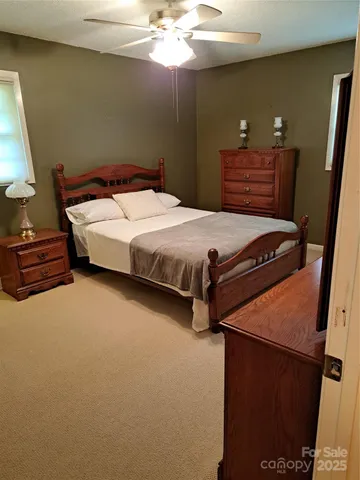 a bedroom with a bed and dresser