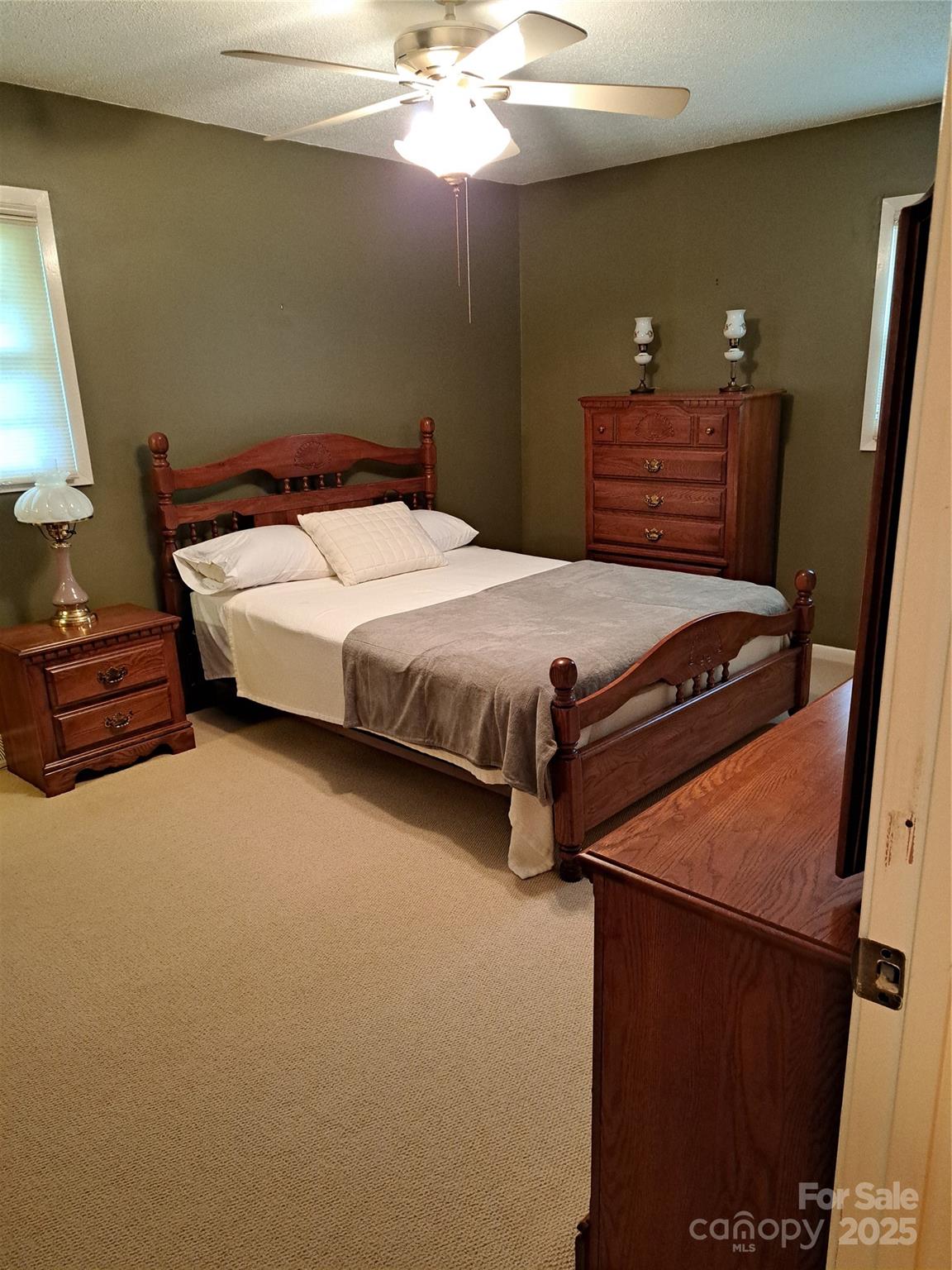 123 Softwind Lane Concord, NC 28025 - Photo 20 of 42 a bedroom with a bed and dresser