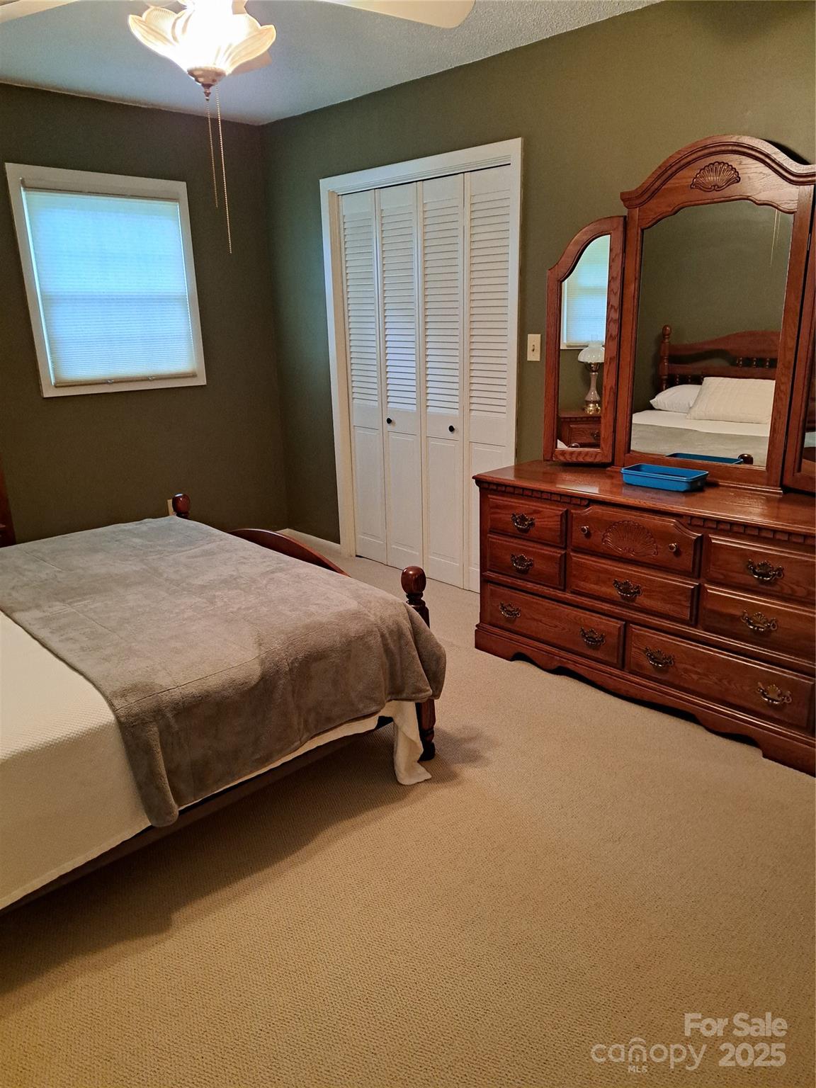 123 Softwind Lane Concord, NC 28025 - Photo 21 of 42 a bedroom with a bed and a chandelier