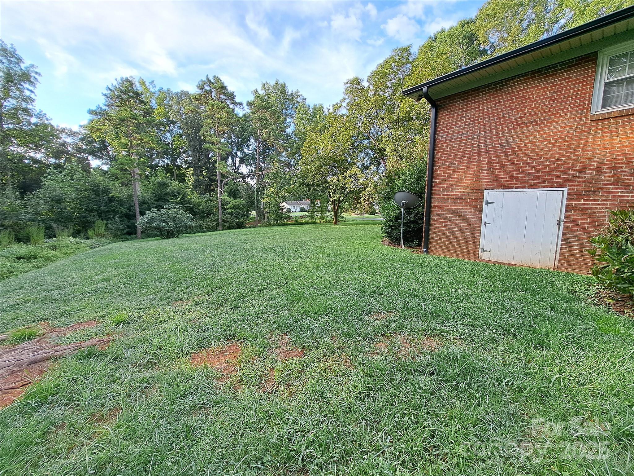 123 Softwind Lane Concord, NC 28025 - Photo 35 of 42 a backyard of a house with lots of green space