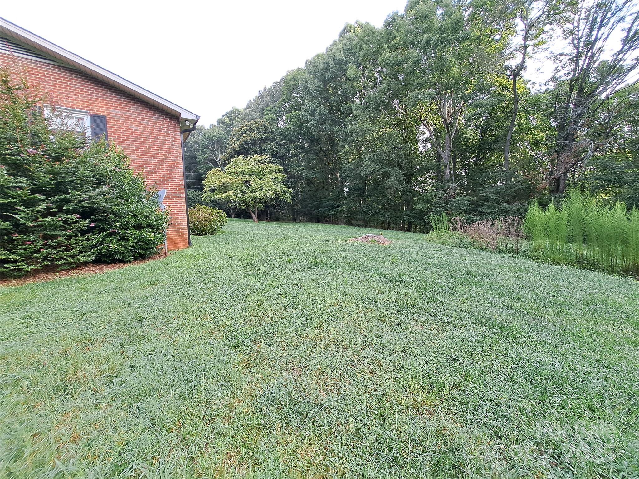 123 Softwind Lane Concord, NC 28025 - Photo 42 of 42 a backyard of a house with lots of green space