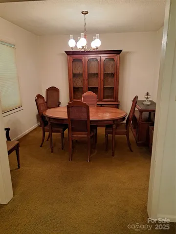 a dining room with furniture and chandelier