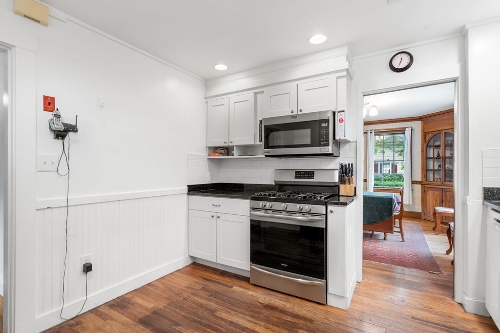 9 Damien Road Wellesley, MA 02481 - Photo 13 of 39 a kitchen with a stove a microwave and wooden floors