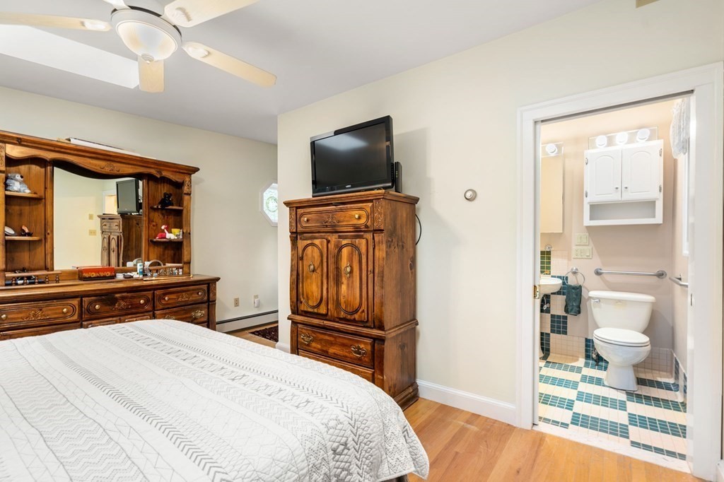 9 Damien Road Wellesley, MA 02481 - Photo 18 of 39 a bedroom with a bed and a flat screen tv