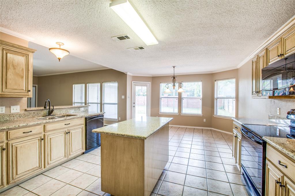 14 Enchanted Court Mansfield, TX 76063 - Photo 13 of 25 a large kitchen with a window and cabinets