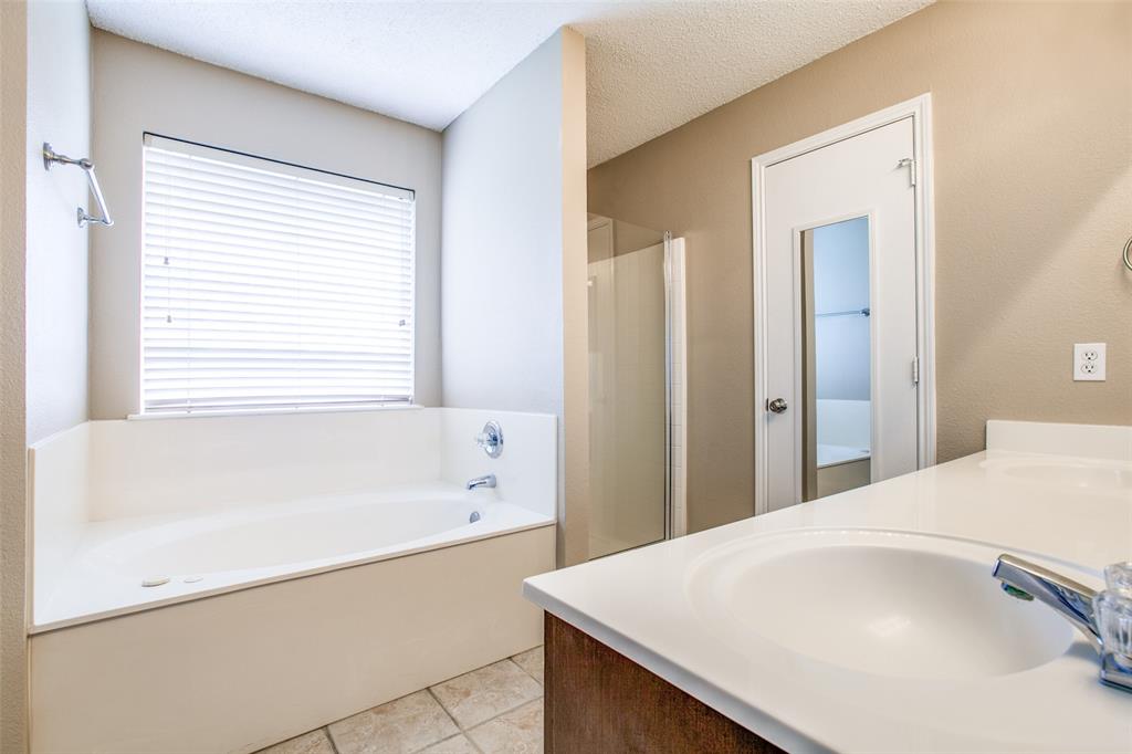 14 Enchanted Court Mansfield, TX 76063 - Photo 15 of 25 a bathroom with a bathtub and a sink