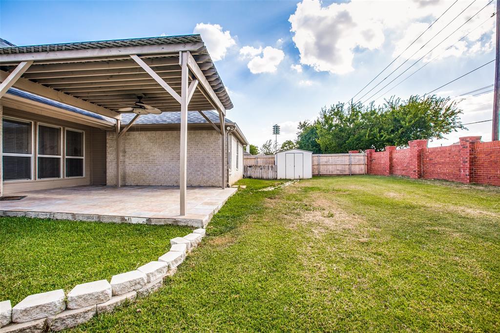 14 Enchanted Court Mansfield, TX 76063 - Photo 23 of 25 a view of a backyard with a large tree