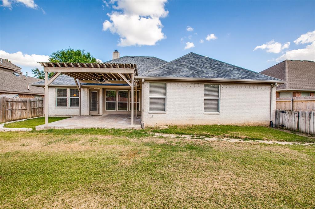 14 Enchanted Court Mansfield, TX 76063 - Photo 24 of 25 a front view of a house with a garden