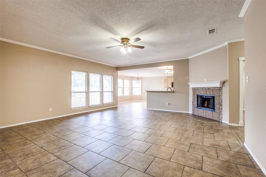 14 Enchanted Court Mansfield, TX 76063 - Photo 6 of 25 a view of an empty room with a fireplace and a window