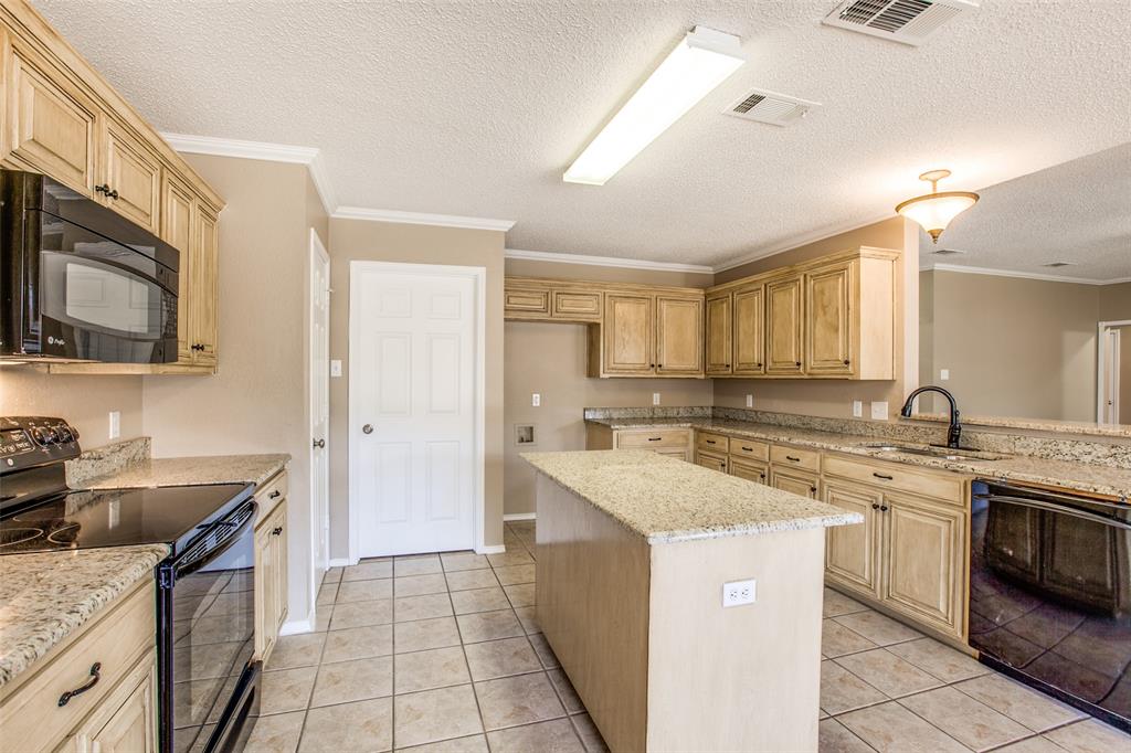 14 Enchanted Court Mansfield, TX 76063 - Photo 10 of 25 a kitchen with a sink stove top oven and refrigerator