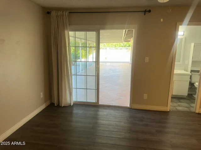a view of wooden floor and windows in a room