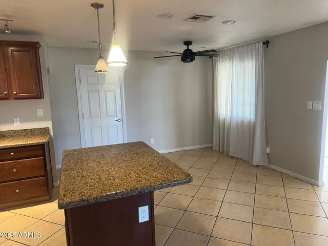 a kitchen with granite countertop a sink and cabinets