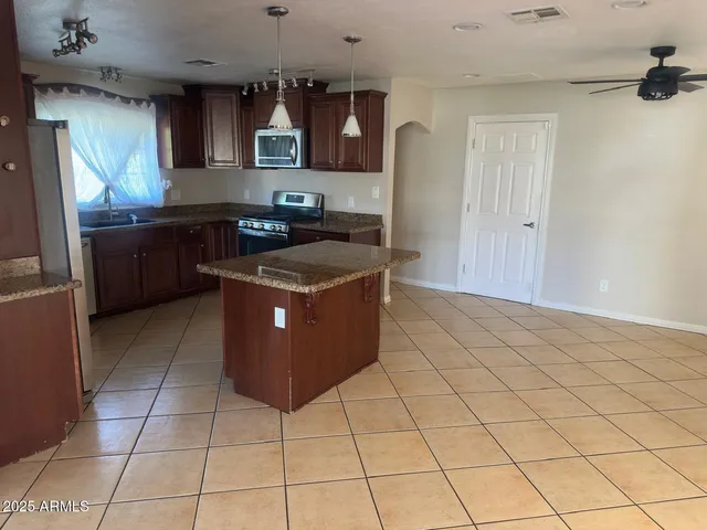a kitchen with stainless steel appliances granite countertop a sink counter space and cabinets