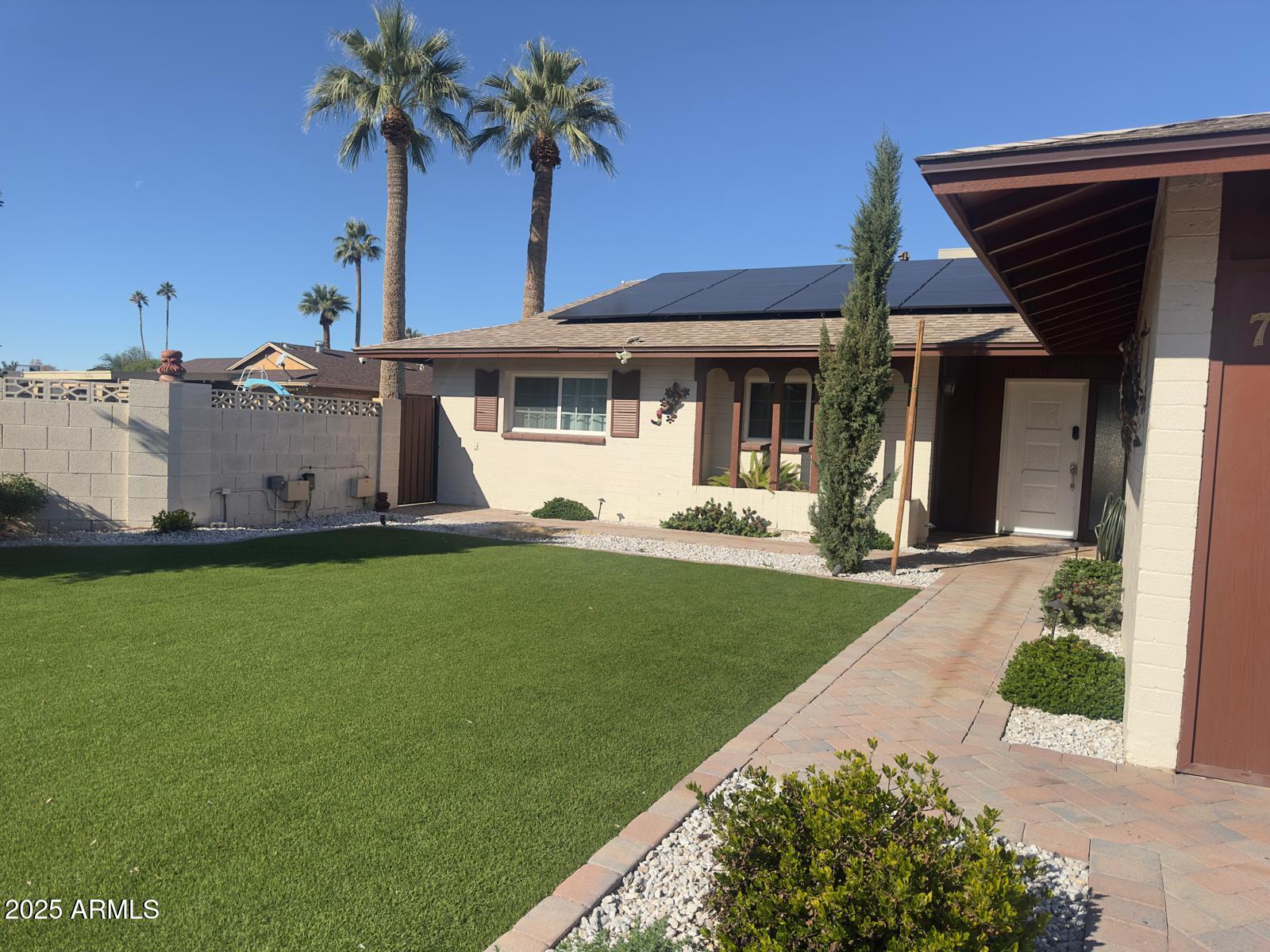 7728 North 47th Drive Glendale, AZ 85301 - Photo 2 of 23 a front view of a house with a garden and yard