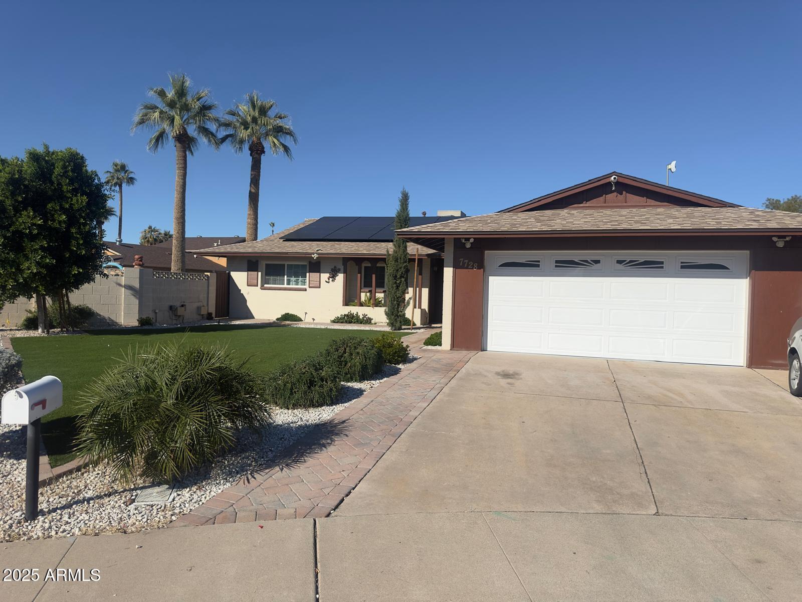7728 North 47th Drive Glendale, AZ 85301 - Photo 3 of 23 a front view of a house with a yard and garage