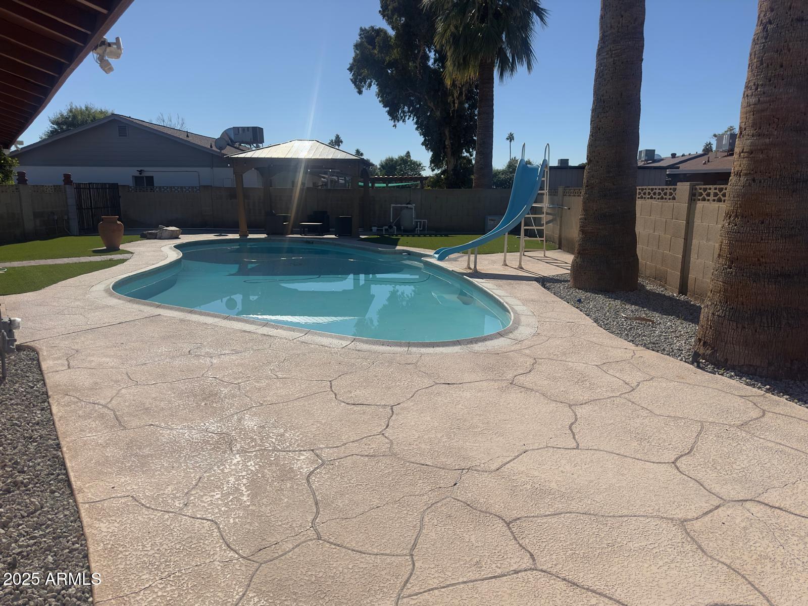 7728 North 47th Drive Glendale, AZ 85301 - Photo 5 of 23 a view of a swimming pool with a yard