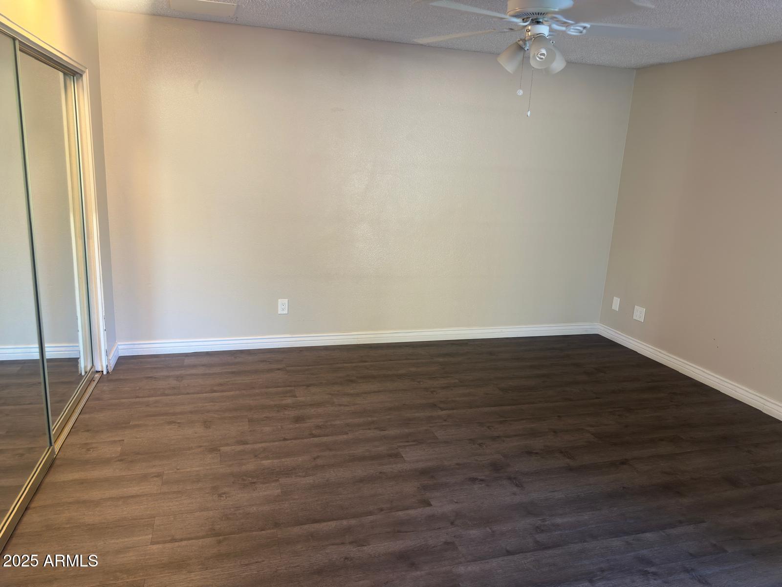 7728 North 47th Drive Glendale, AZ 85301 - Photo 10 of 23 a view of an empty room with wooden floor