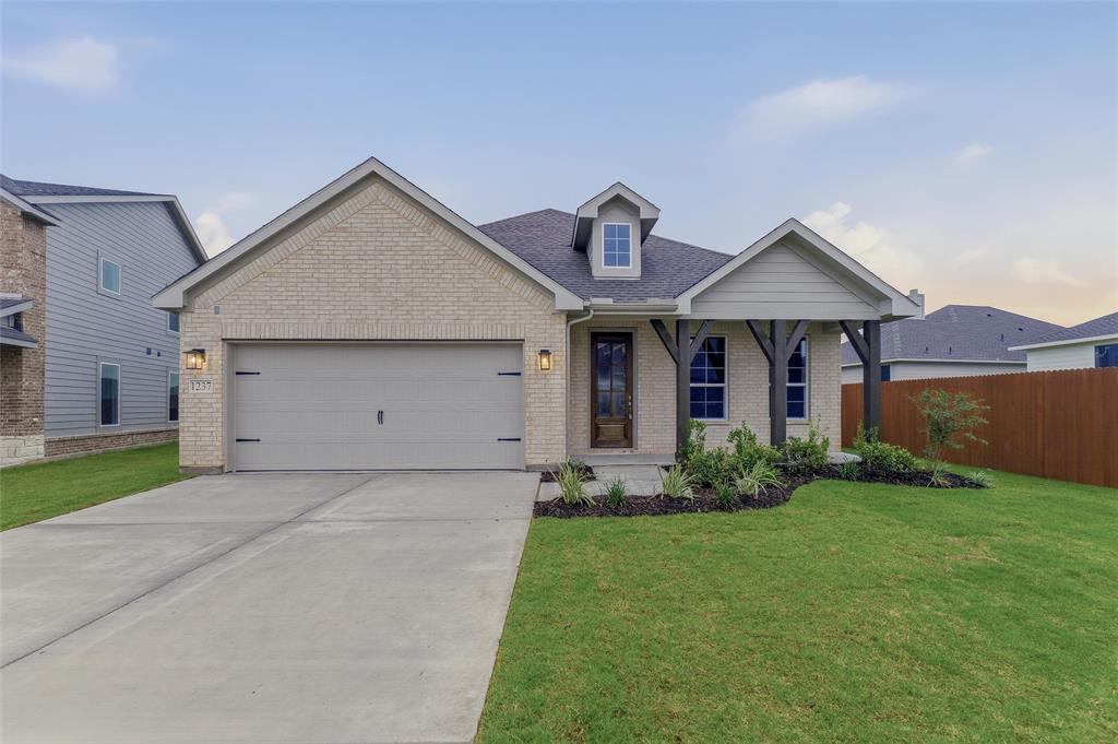 1237 Frio Drive Springtown, TX 76082 - Photo 3 of 25 Light brick exterior with an attached two-car garage