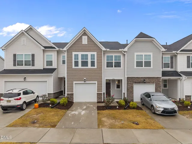 a front view of a house with parking space
