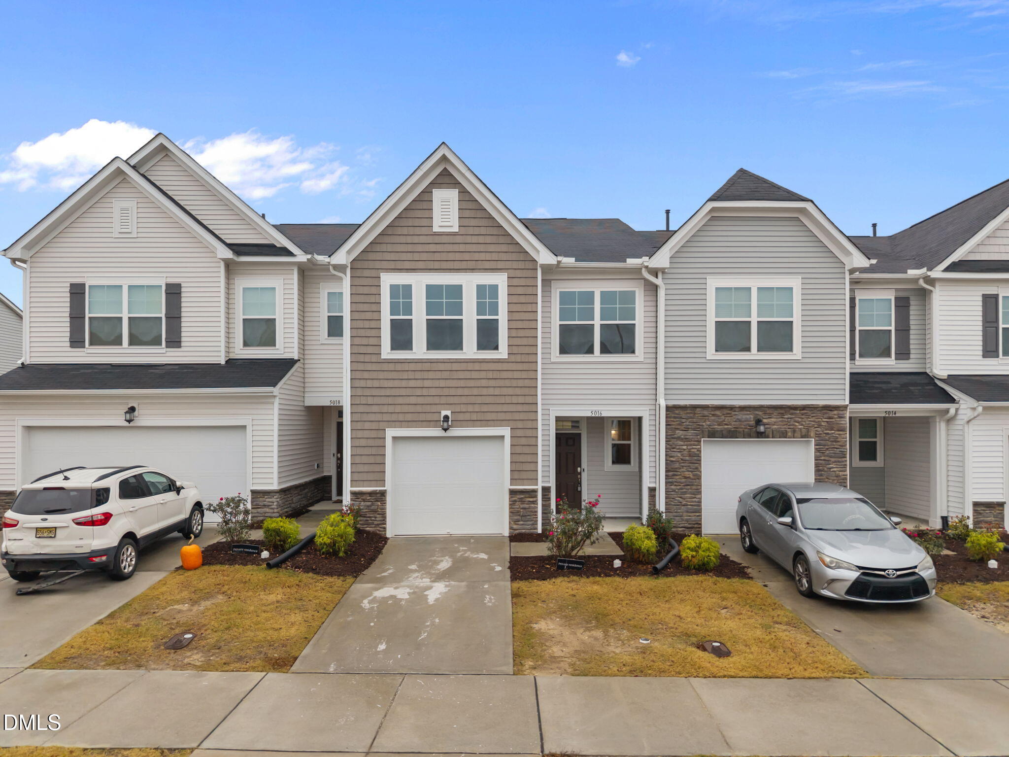 a front view of a house with parking space