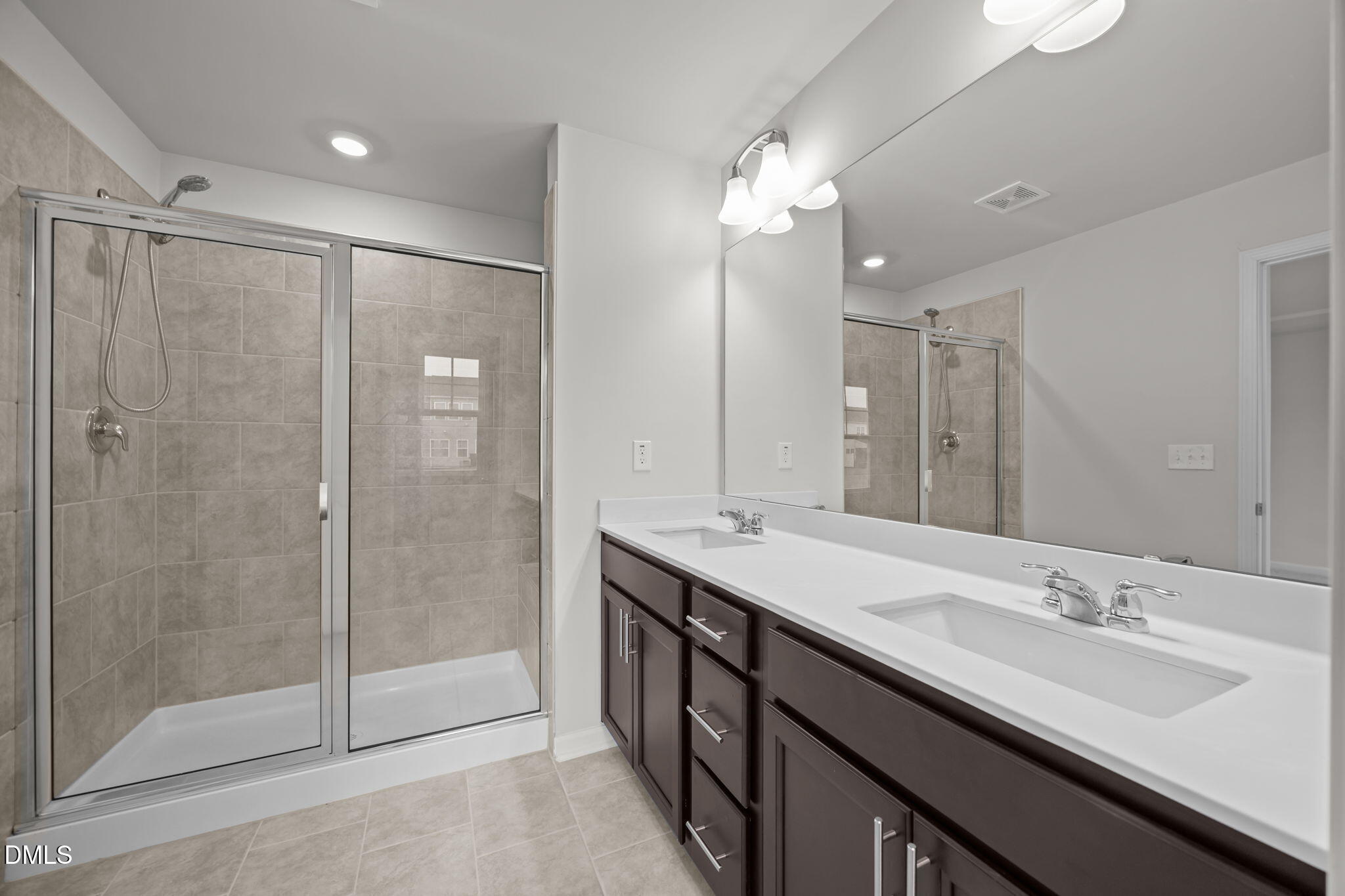 5016 Kota Street Raleigh, NC 27610 - Photo 11 of 37 a bathroom with a double vanity sink mirror and shower