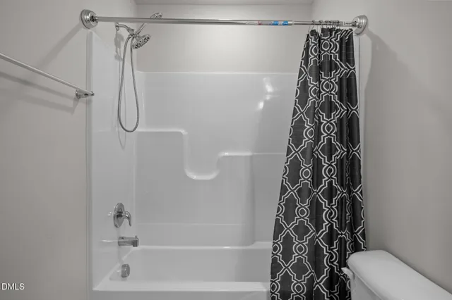 a bathroom with a shower and a toilet