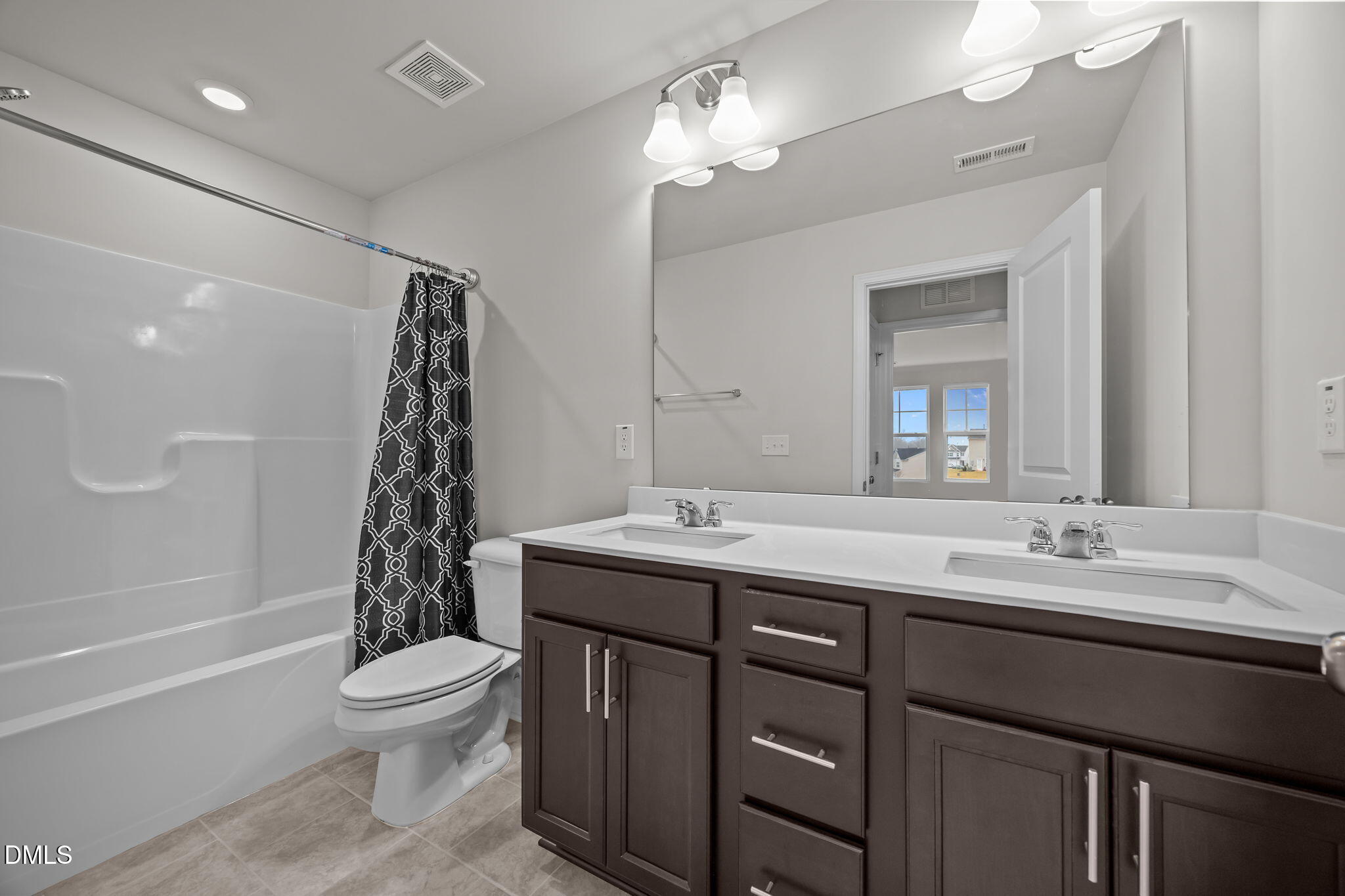 5016 Kota Street Raleigh, NC 27610 - Photo 17 of 37 a bathroom with a double vanity sink toilet and shower