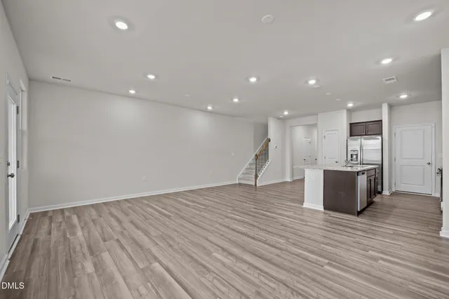 a view of kitchen with kitchen island and stainless steel appliances
