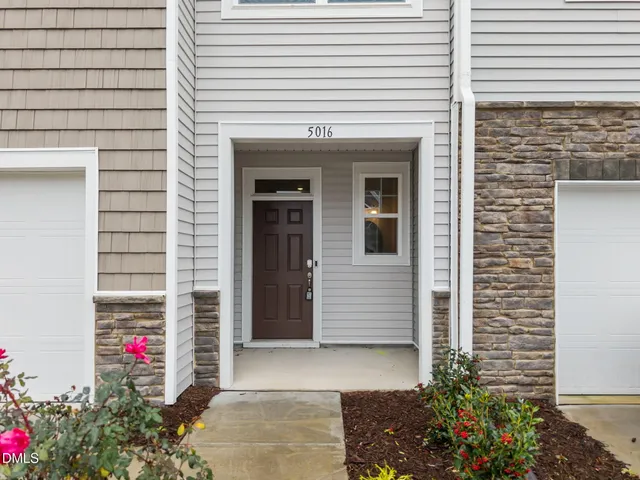 a front view of a house with a garage