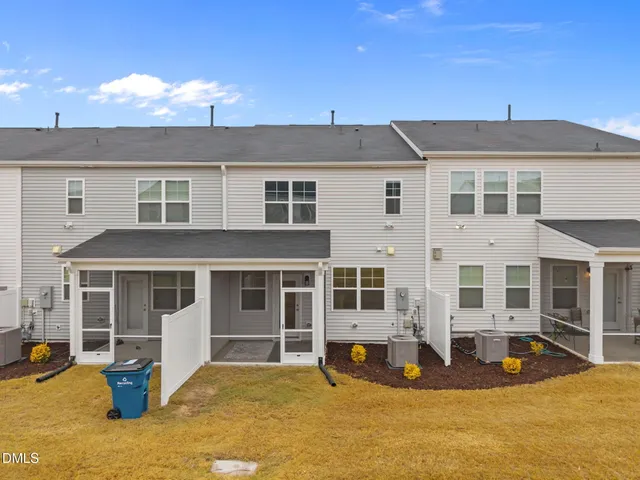 a front view of a house with a yard outdoor seating and garage
